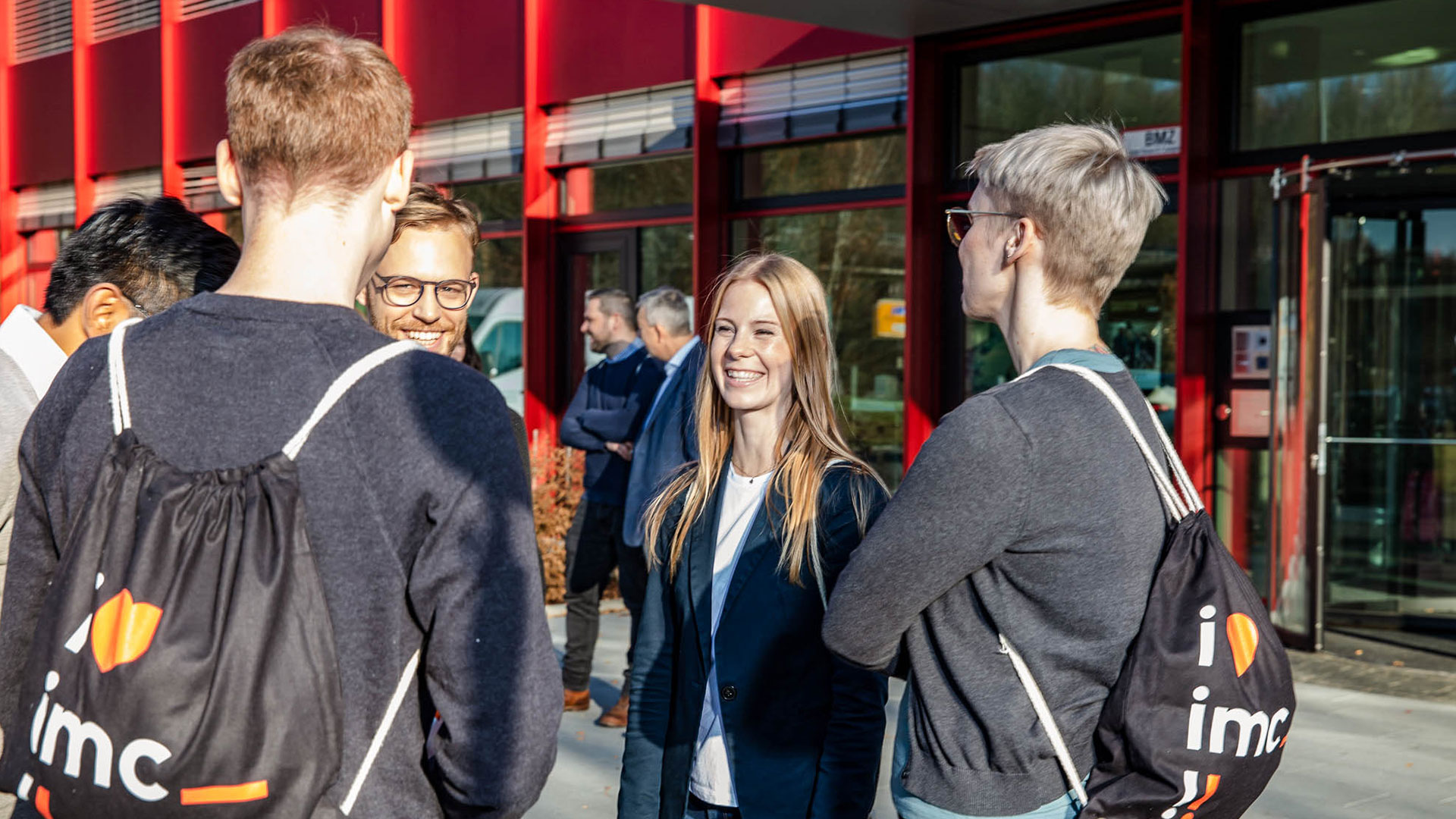 imc employees talking to one another outside the offices