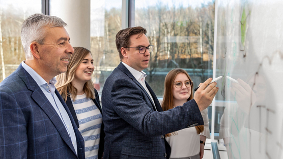 image of people determining perfect training fit on whiteboard