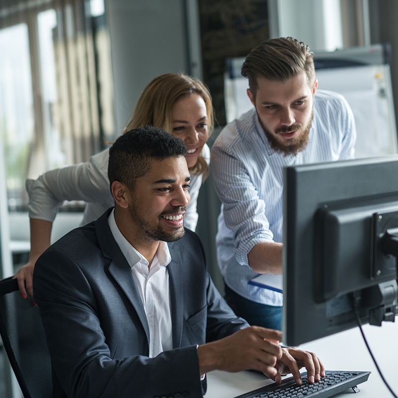 colleagues collaborating around computer screen