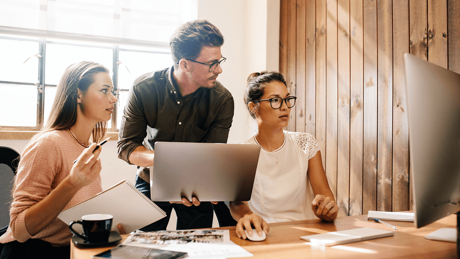 colleagues gathered around computer