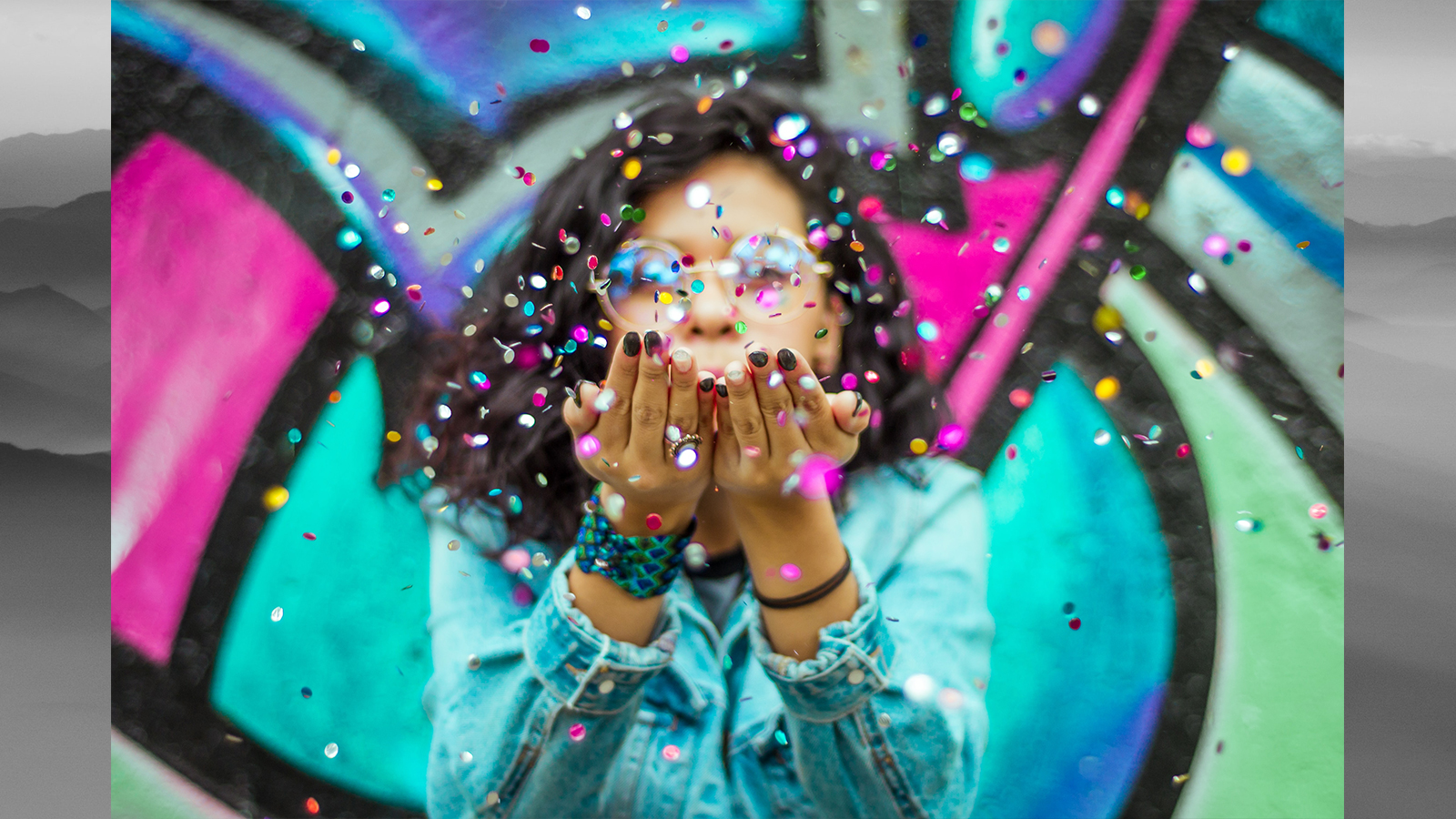 Young woman blowing confetti for Diversity Day