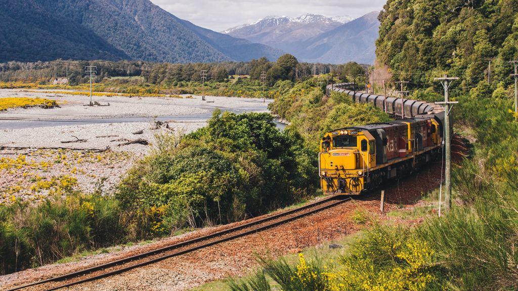 kiwirail vehicle travelling through mountain pass