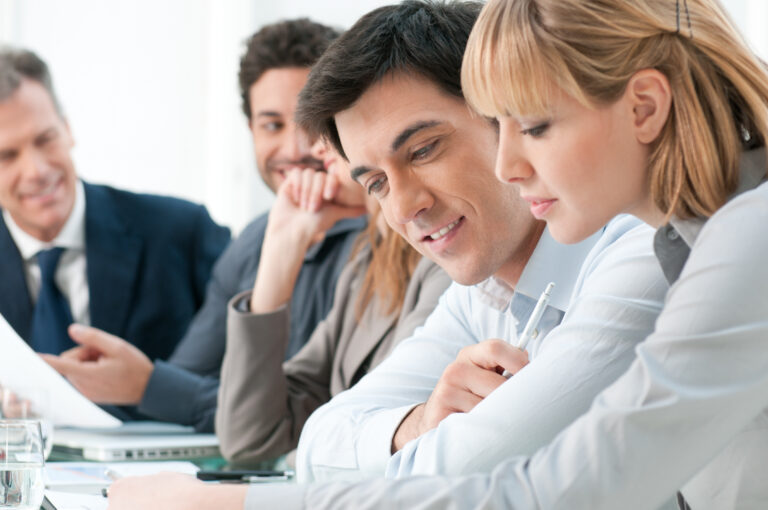 Smiling,Business,Colleagues,Working,Together,During,A,Meeting,In,Office