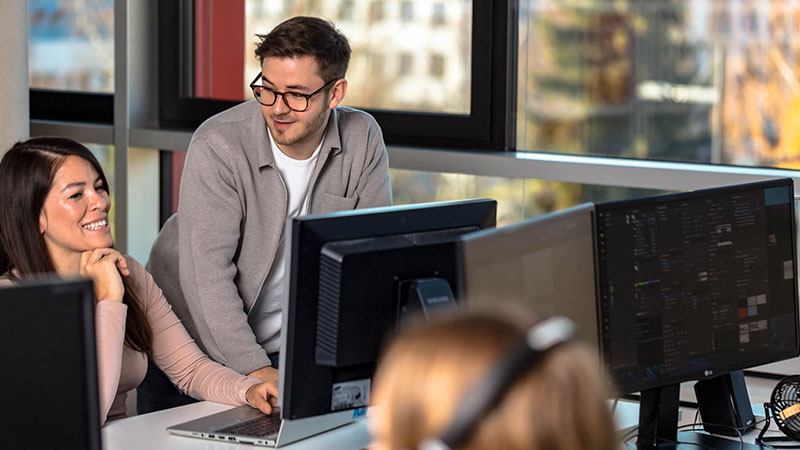 ux designers discussing work on computer