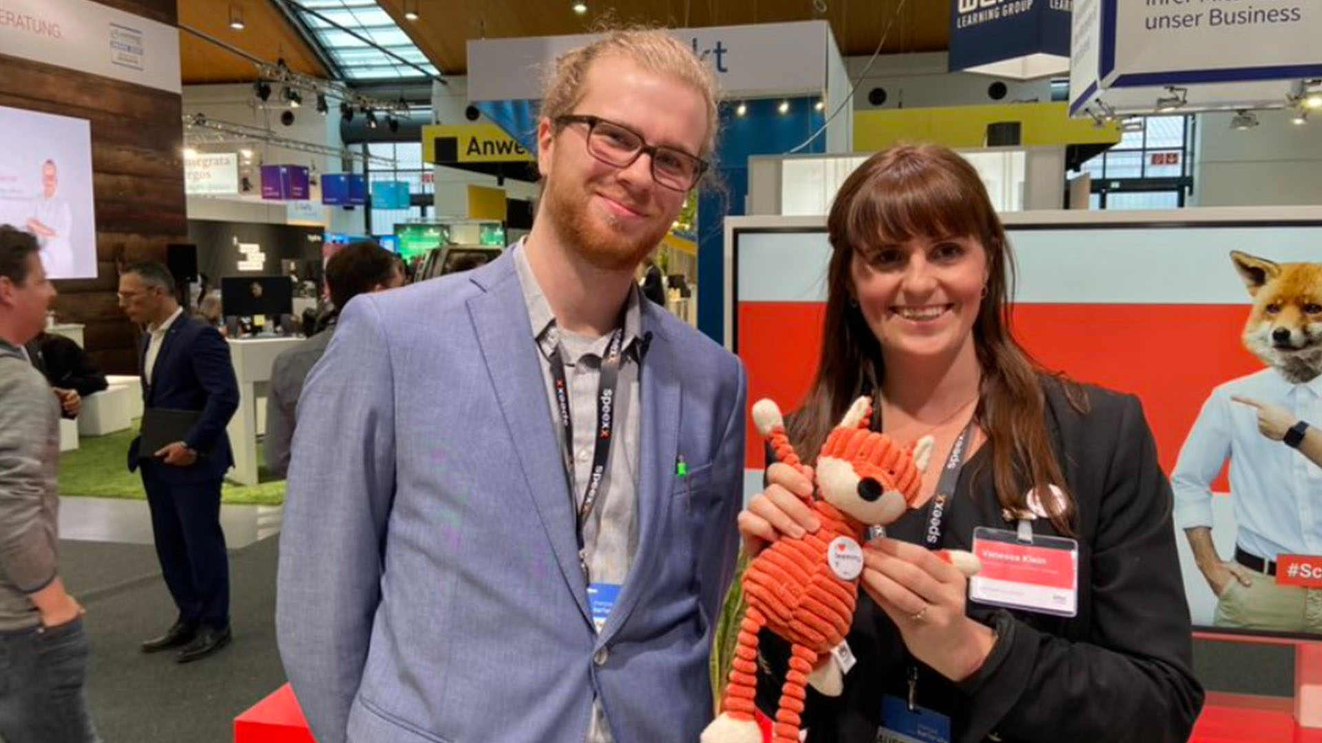 imc employees at conference with soft toy