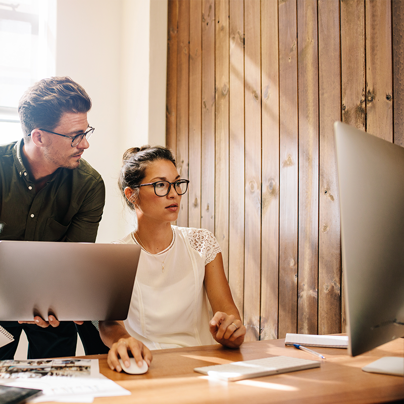 colleagues looking at computer