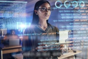 Woman in Cyber Security staring at a screen with lines of code