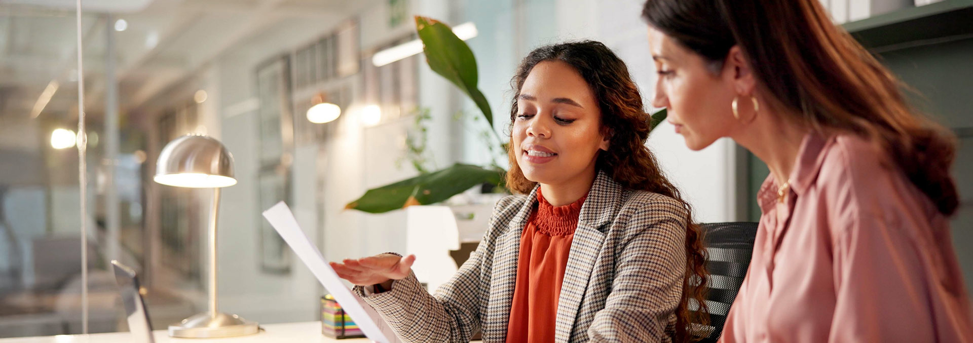Two individuals looking at a data printout