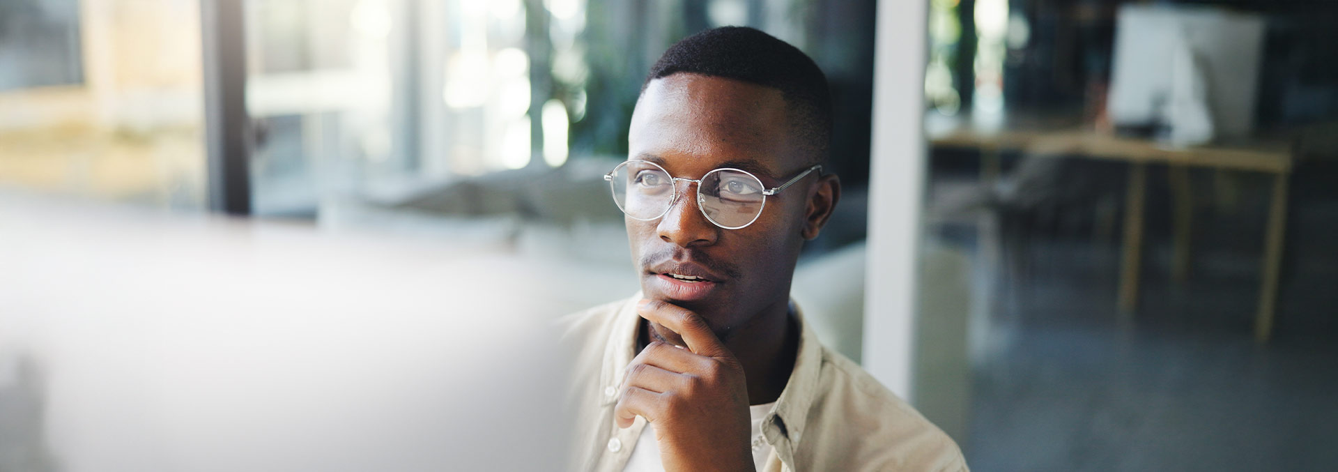 Person contemplating while looking at a larger screen