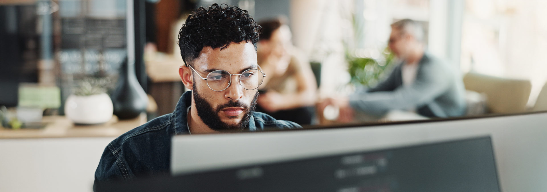 Person sitting a desk looking at their monitor